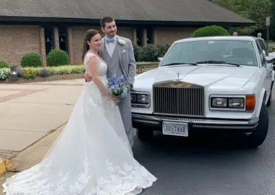 Wedding couple with white Rolls Royce