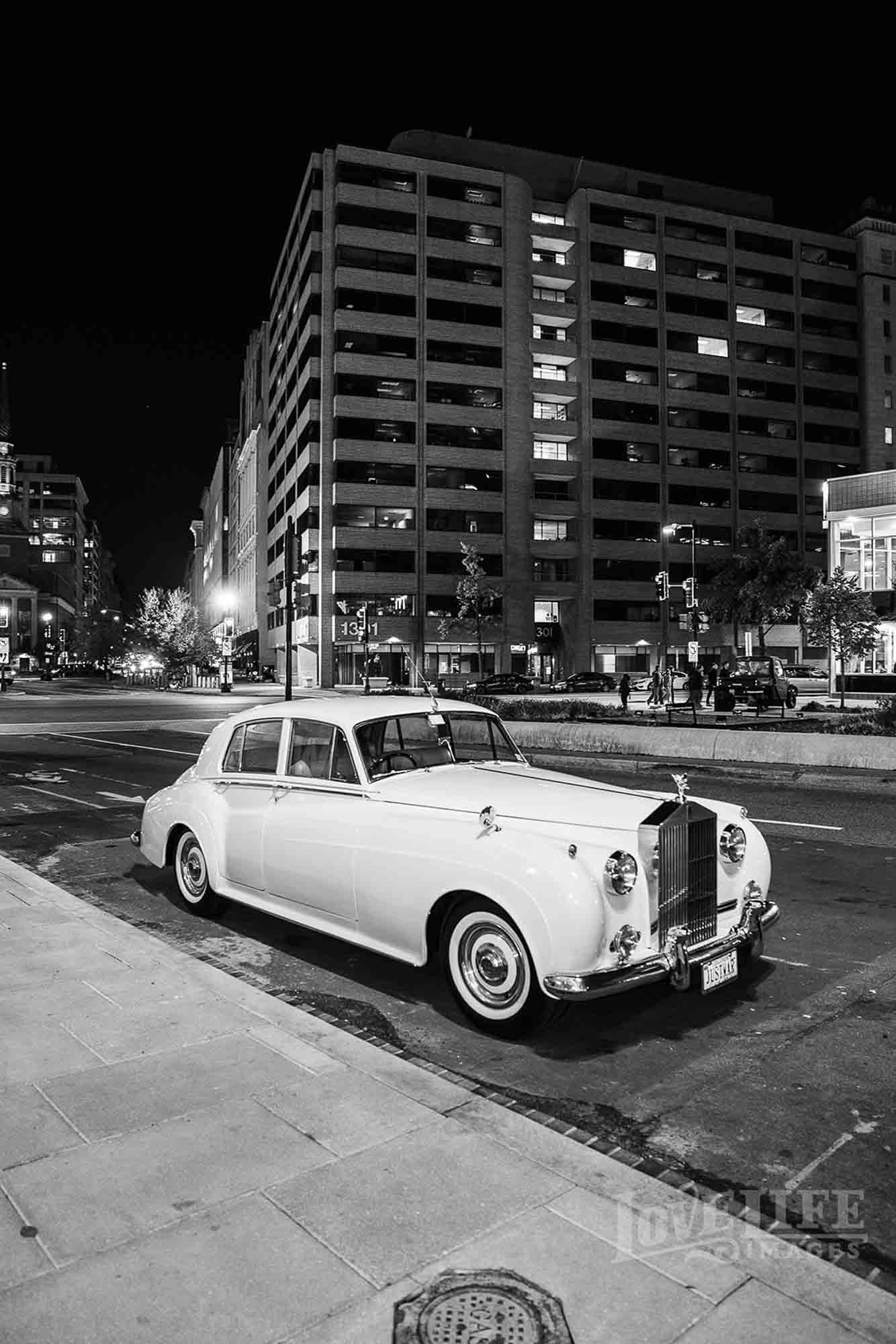 Black and white photo of a classic Rolls Royce in downtown Washington DC