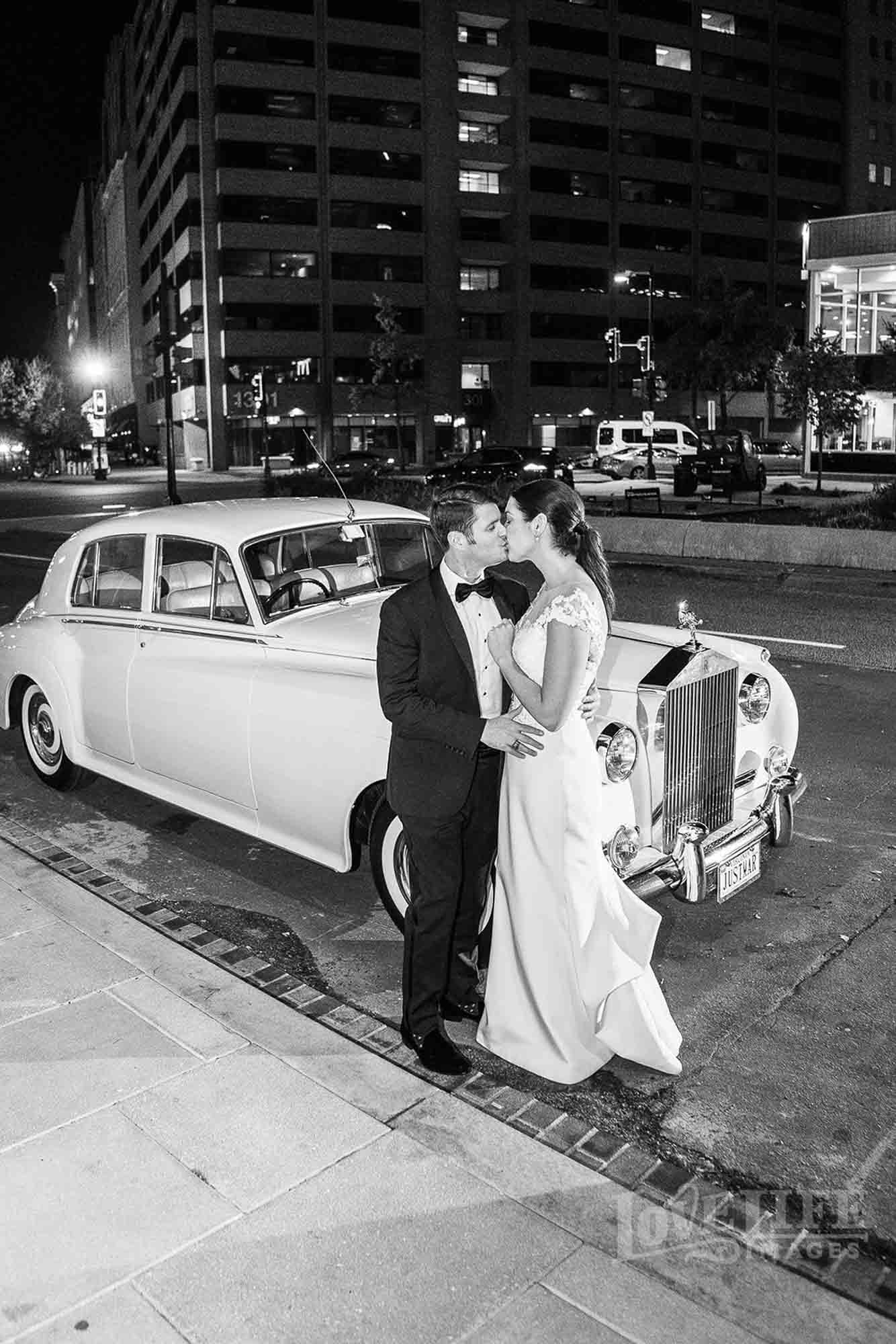 Newlyweds pose at the front of our Rolls-Royce limo in DC